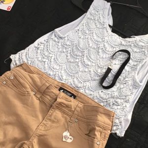 A blue kids top,beige shorts,and a Black choker